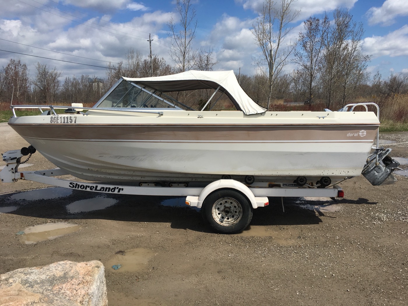 1981 Doral 16-foot bowrider on a trailer beside a gravel launch