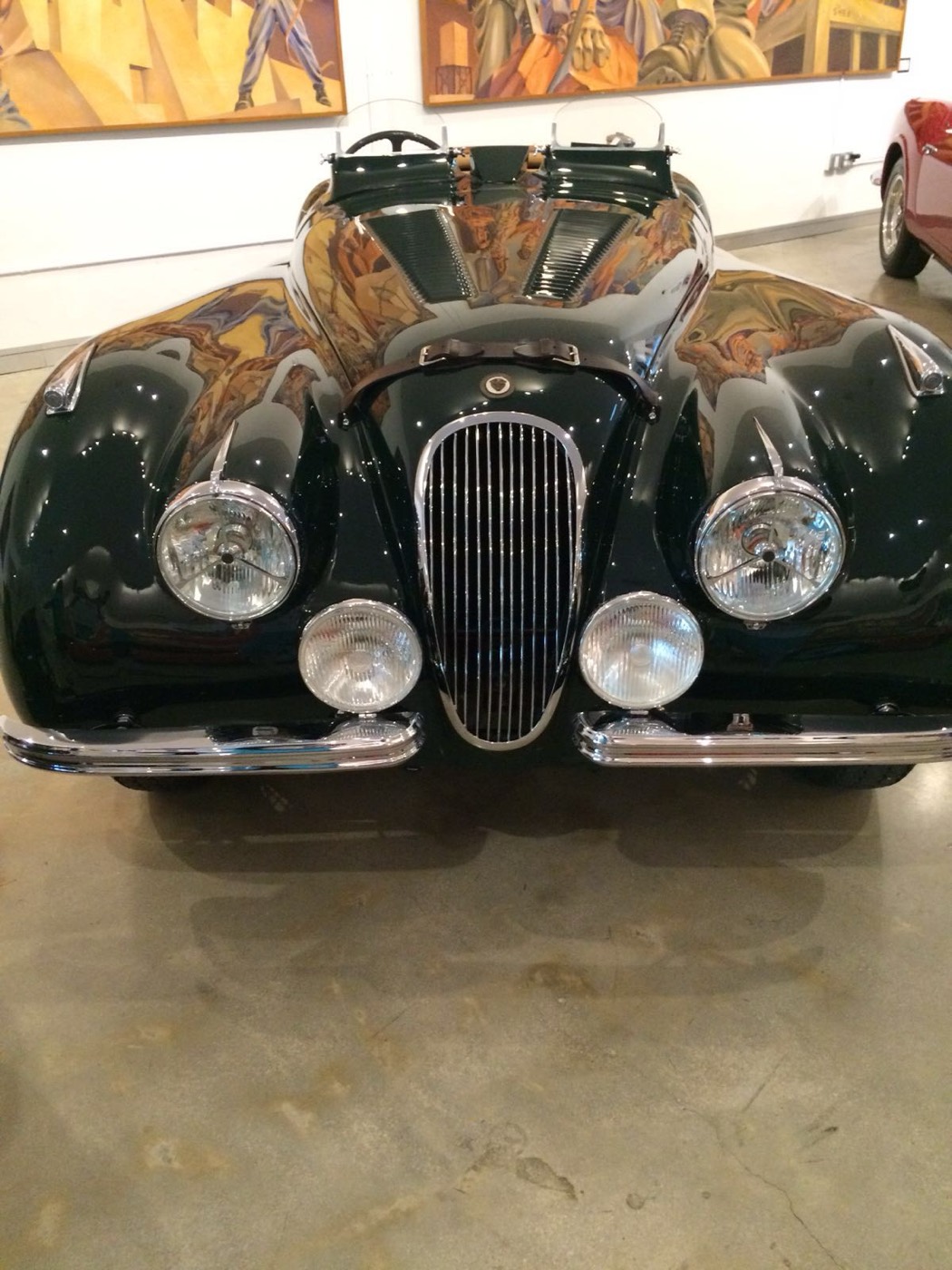 Dark green Jaguar XK120 roadster, front view