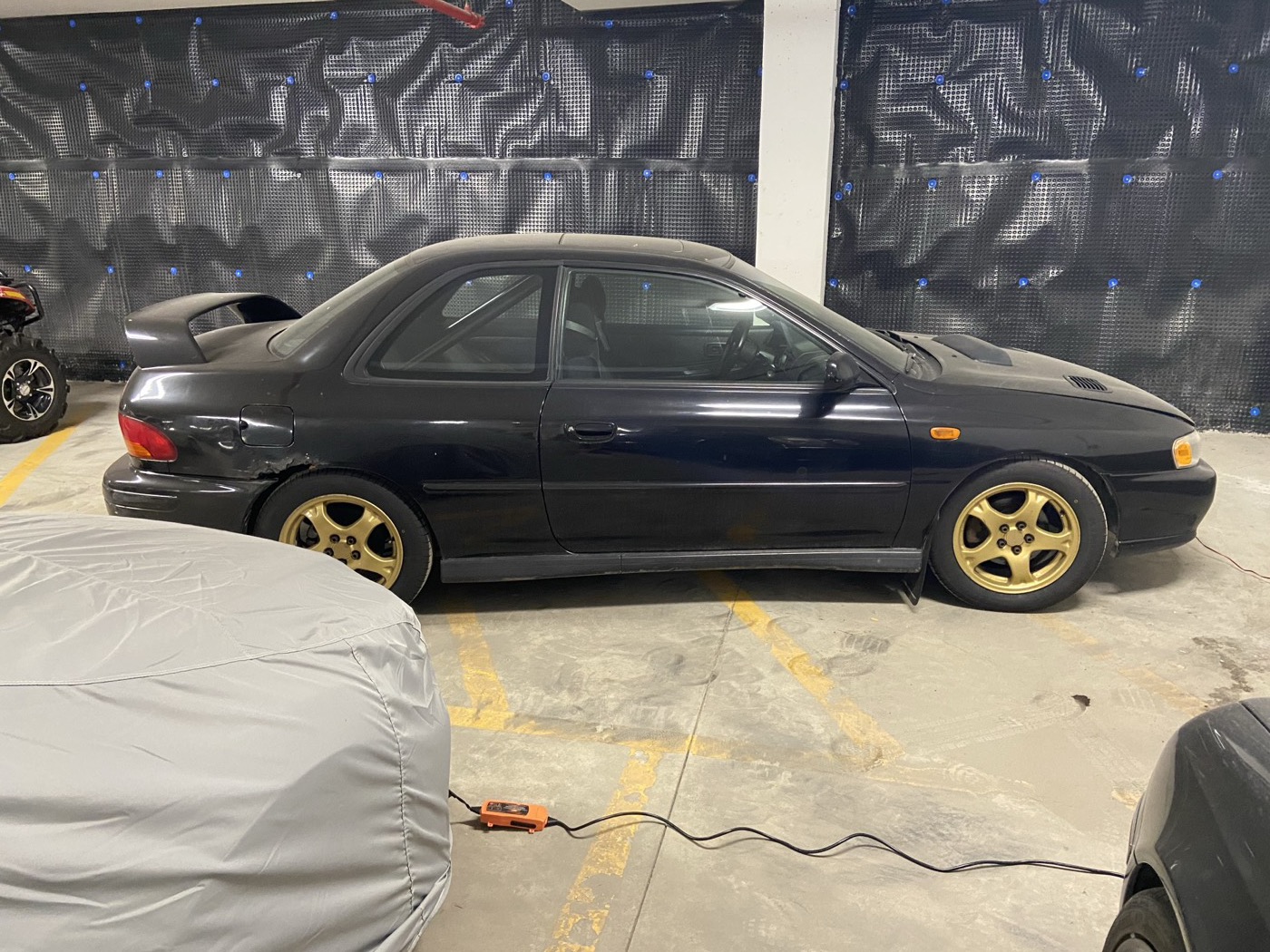 Black 2000 Subaru Impreza 2.5RS coupe with gold wheels, side view